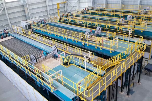 Series of industrial sludge filtration tanks in refinery hall