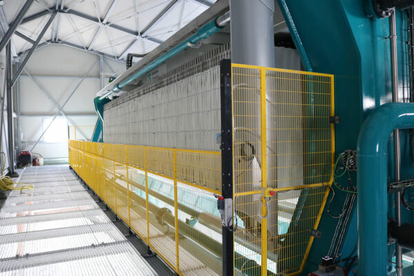 Industrial filter press line processing aggregate wash sludge