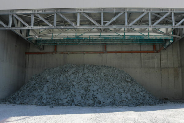 Processed aggregate stockpile inside concrete storage bunkers