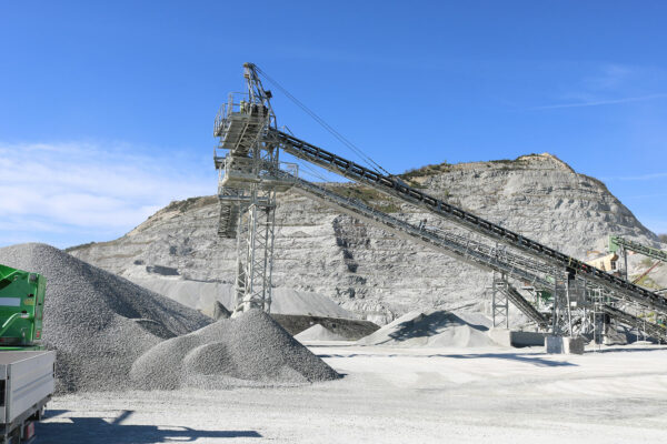 Aggregate piles and conveyor system at treatment plant quarry
