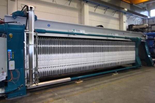 Side view of filter press cloth plates inside power plant slurry dewatering system