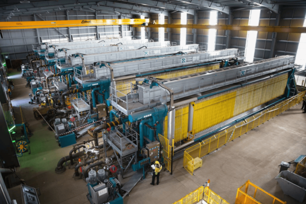 Operator inspecting multiple filter presses for bentonite slurry dewatering process